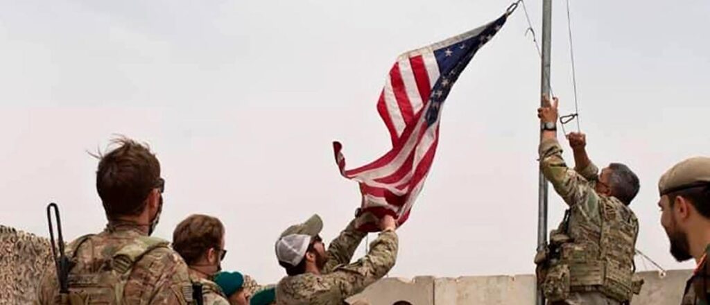 Soldiers Putting Up American Flag In Afghanistan